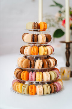 Colorful french macaron tower on clear tiered display stand