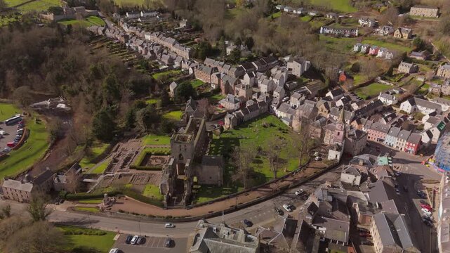 Drone view of Jedburgh, Scottish Borders buildings and hills on a sunny day
