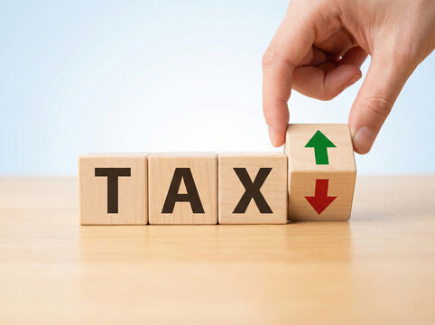 tax concept wooden cubes with hand placing arrow block showing increase and decrease finance signal