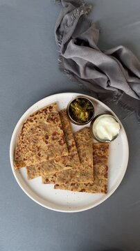 Crispy Onion Paratha Cooking on Tawa &ndash; Stuffed Indian Flatbread Close Up with Golden Texture