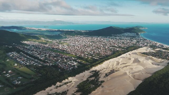 Aerial view of the town of Ingleses and its dunes during sunrise on the island of Santa Catarina. Florianopolis, Brazil
