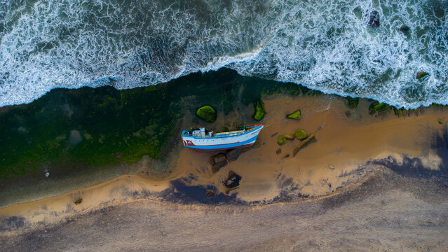 The capsized boat on the beach.
