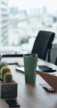 Conference, office and interior with furniture, laptop or tablet for workshop or presentation. Empty, boardroom and documents with technology on table or desk of modern space, equipment or workplace