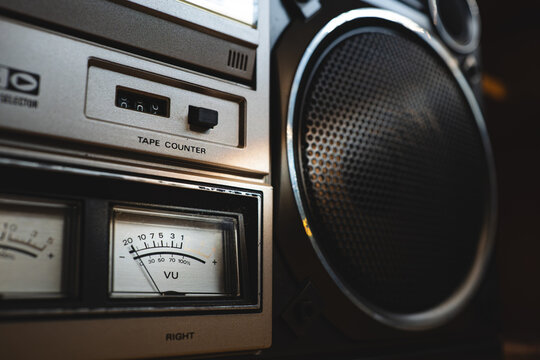 Vintage 80's boombox stereo speaker and cassette player with vu meter in a retro home interior. Close up shot, natural light, no people