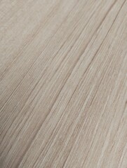Naklejka premium Light brown wood grain texture background. Natural timber pattern with straight fine lines. Ideal for minimalist furniture surface, laminate, and interior design backdrop.