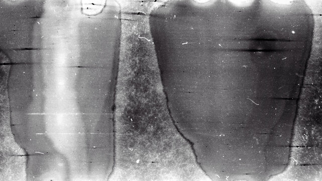 Blank grained film strip texture background with heavy grain, dust and light leak. Old expired moldy photographic film scan.