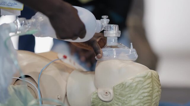 Medical student practicing bag valve mask ventilation on mannequin