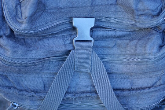 One black plastic carabiner clip on a fabric army backpack harness