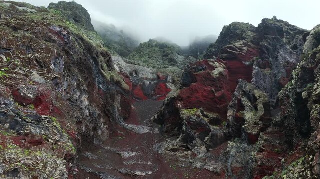 Aerial Panoramic View Dramatic Multi Colored Volcanic Cliffs Red Basalt Clouds Mist El Hierro Canary Islands Spain