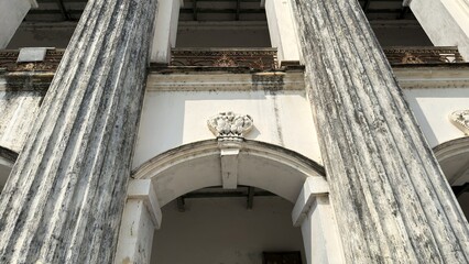 Ornate Archway Detail Between Fluted Columns on a Historic Building Facade © IT'S ORA