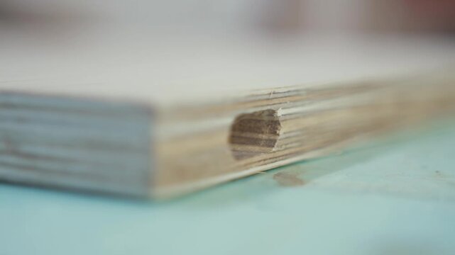 Close up shot of wood block with hole in center, panning motion from right to left, showing details