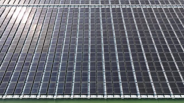 High angle view of floating PV panels and closed-house poultry farm for energy-efficient livestock production.