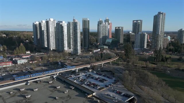 Elevated Railways Of SkyTrain Along King George Boulevard In Surrey, British Columbia, Canada. Aerial Tracking Shot