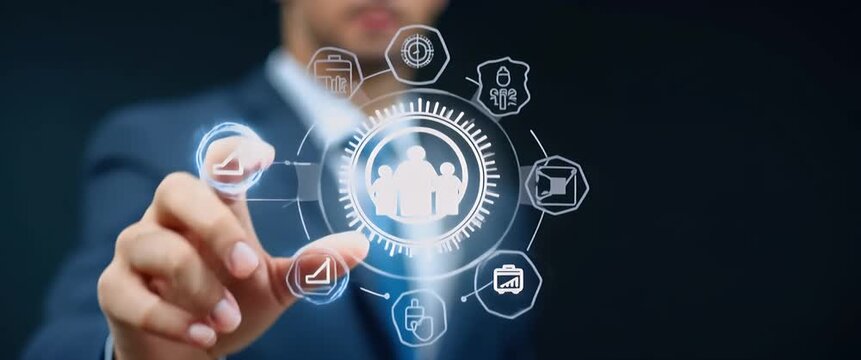 Businessman interacts with futuristic digital interface, finger tapping icons; camera slowly pans to reveal more UI elements in a sleek, cinematic style.