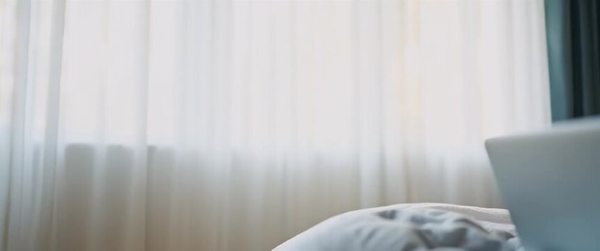 Happy mixed race teen schoolgirl engages in virtual remote e learning using laptop in bedroom wearing headphones looking at camera participating in distance education classes studying online at home. 