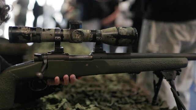 Military sniper rifle with camouflage scope and bipod