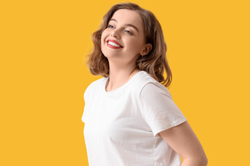 Obraz premium Beautiful young woman with bob hairstyle on yellow background