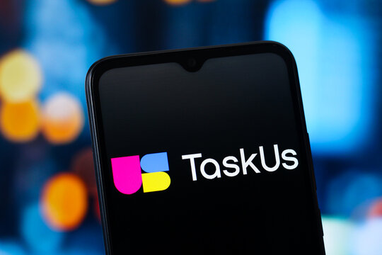 In this photo illustration, the TaskUs (Task Us) logo is seen displayed on a smartphone screen.