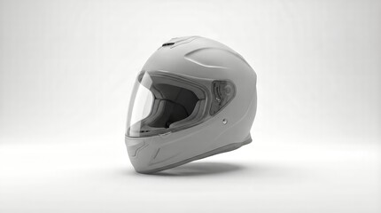 Fototapeta premium Full face grey snowmobile helmet sitting on a clean white background, creating a high key product showcase for winter sports safety, protection, and modern equipment design