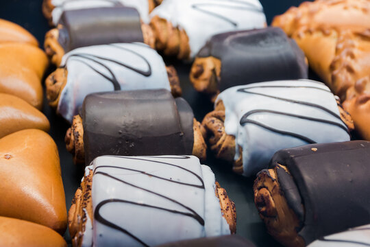 Photos of neat buns with filling and icing on shelves
