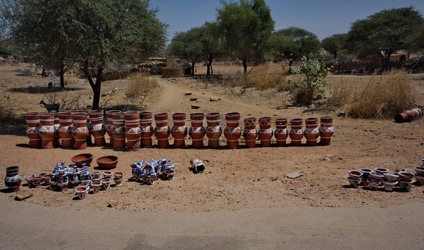 Central Africa, Chad, Mongo.  a view of painted clay vessels of various sizes and shapes offered for sale on the side of the road.
