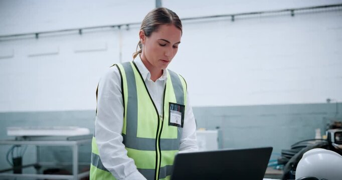 Woman, laptop and typing at factory for robotics with thinking, review and futuristic engineering career. Person, computer and technician with report, machine learning or problem solving at warehouse
