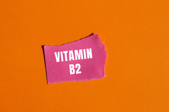 Vitamin B2 message written on ripped torn paper background. Conceptual Vitamin B2 symbol. Copy space.