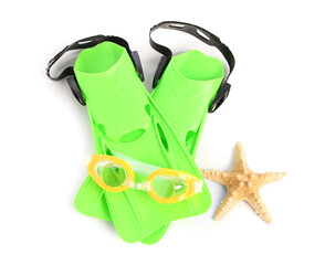 New swimming goggles, starfish and flippers on white background © Pixel-Shot