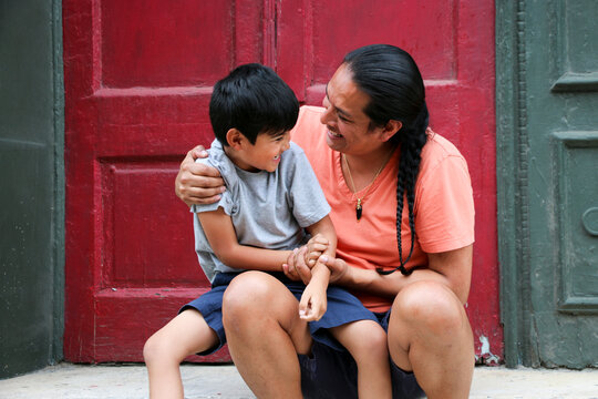 Native American Father and Child Sitting Together Showing Family Connection
