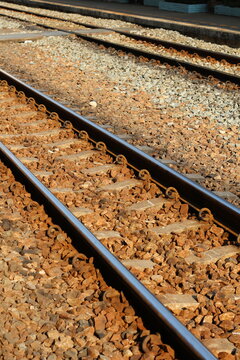 Close-up view of parallel train tracks with gravel ballast and concrete sleepers
