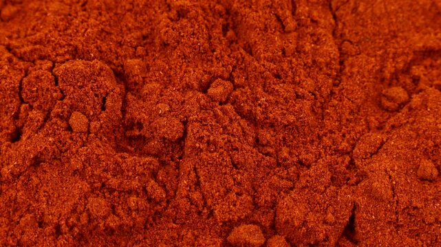 Red smoked paprika powder circle rotation close up
