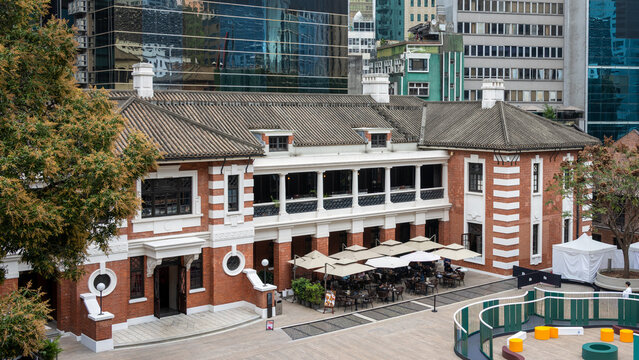 Hong Kong, China, 27 February 2026. Tai Kwun heritage complex with restored colonial architecture contrasted by modern glass skyscrapers in Central district