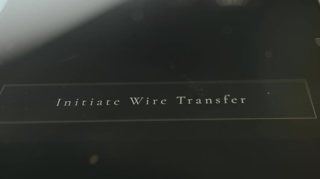 Person taps the option Initiate Wire Transfer, close-up view