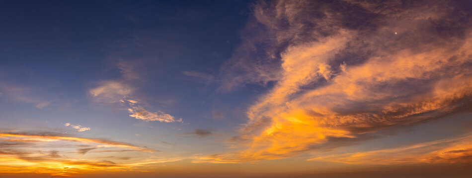 Getting dark at sundown. Sunset sky with scattered clouds of bright colors