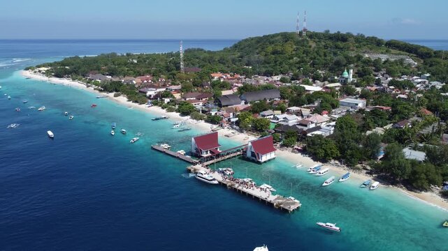 Aerial drone hovering above harbor with left coastline of Gili Trawangan, Indonesia.