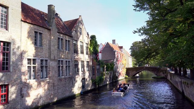 Bruges, Belgium &ndash; September 14, 2024 &ndash; Historical Boat Tour on the Groenerei Canal Bruges Belgium 4K UHD. Scenic tourist canal tour on the Groenerei canal near the Meebrug stone bridge. Bruges.
