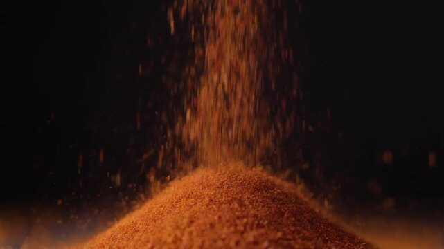 chili powder falling abstract motion, macro cinematic shot, dark background, detailed texture