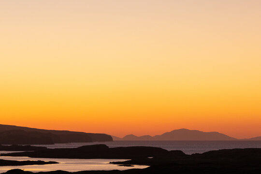 Magical night light at the Loch Duvegan archipelago with small Eilean M&ograve;r island after sunset.