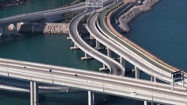 Aerial view of complex highway interchange bridge traffic over water