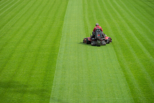 Mowing grass at the football stadium