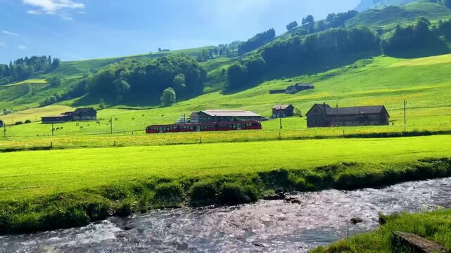 Aerial drone footage of vintage red train traveling through lush green countryside valley in summer