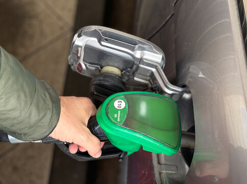 Car refueling with E10 gasoline at petrol station close-up, Man pumping car tank with 95 octane petrol. Rising fuel prices and supply chain issues, Fuel shortage, logistic