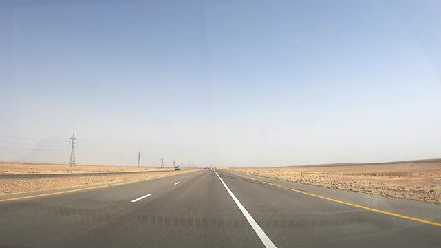 Driving on a highway in the Jordan desert