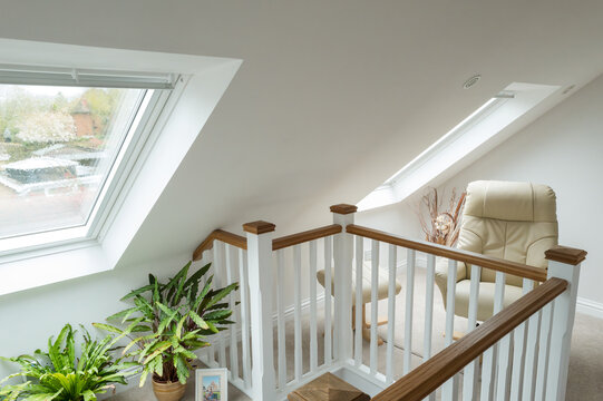 View of a newly finished loft conversion on a private bungalow in Britain. The upstairs is in the loft space, skylight windows help create a light and airy atmosphere.