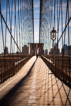 Walking across the Brooklyn Bridge in New York City.