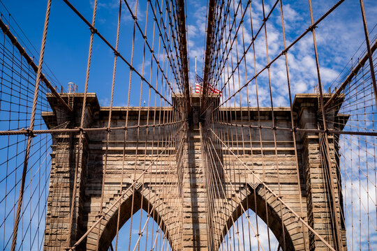 Walking across the Brooklyn Bridge in New York City.