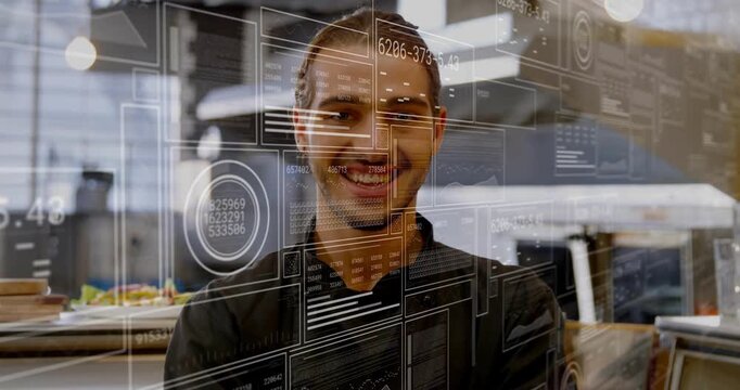 Smiling chef wearing black jacket uncrossing arms, relaxing in kitchen as camera shifting up, HUD