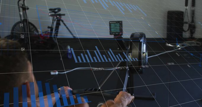 Man grabbing handle and rowing on machine in gym, animated charts tracking fitness metrics