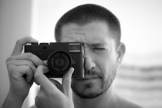 A man posing with a camera.