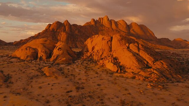 Drone shot over Spitzkoppe in Namibia desert sunset cinematic